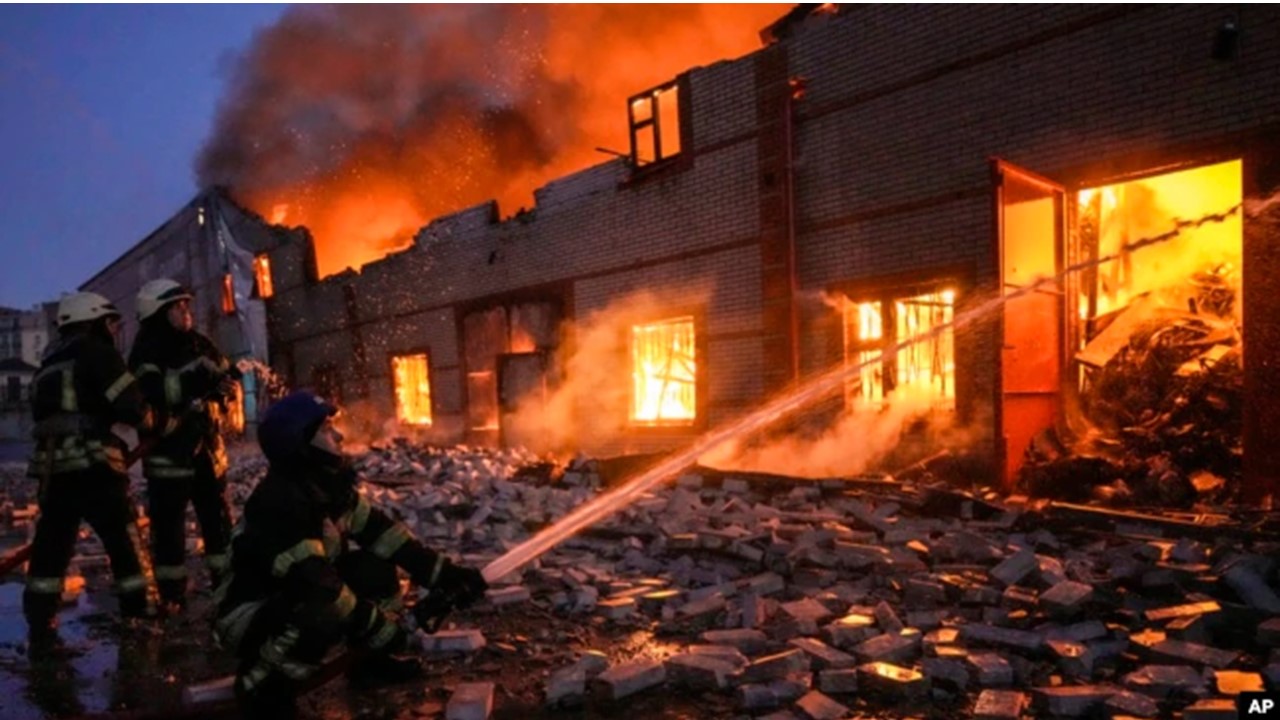 Ukrainian firefighters extinguish a blaze at a warehouse after a bombing in Kyiv March 17 2022